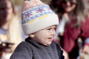 A happy baby smiling after opening a gift.